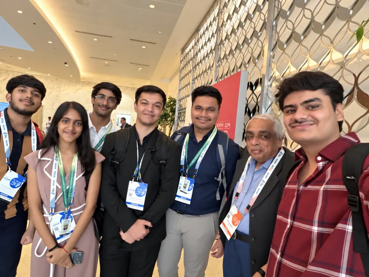 Students meeting a senior attendee at the fintech event; retouched photograph