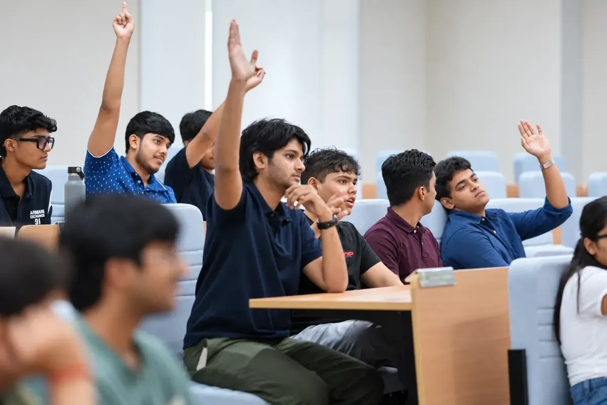 Students raising their hands during an interactive learning session